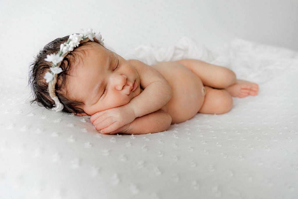 newborn photo of baby on her side