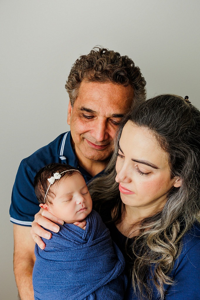 mom, dad and newborn baby portrait