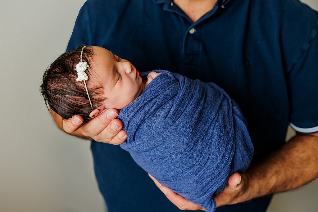 dad holding newborn baby girl