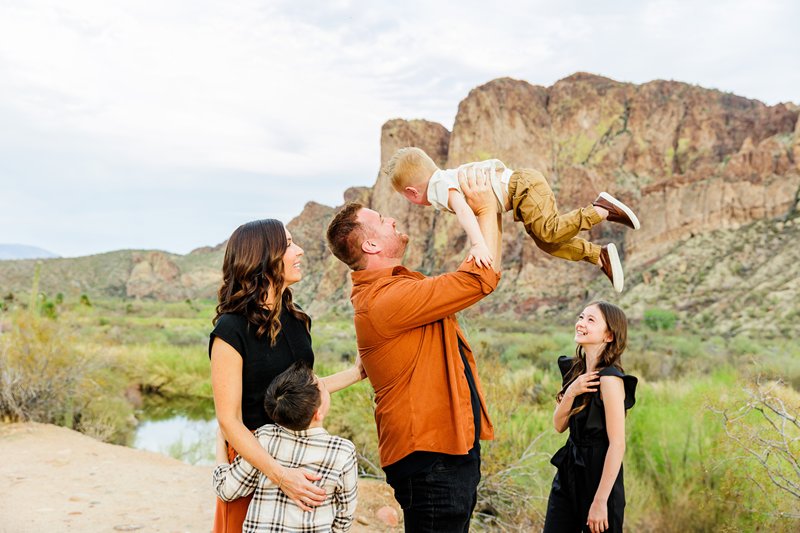 family interacting by the mountain