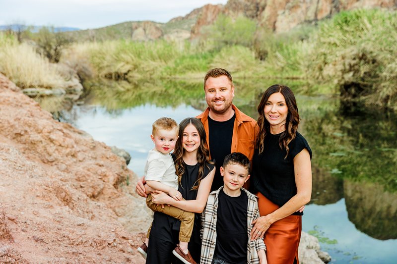 family by the river water