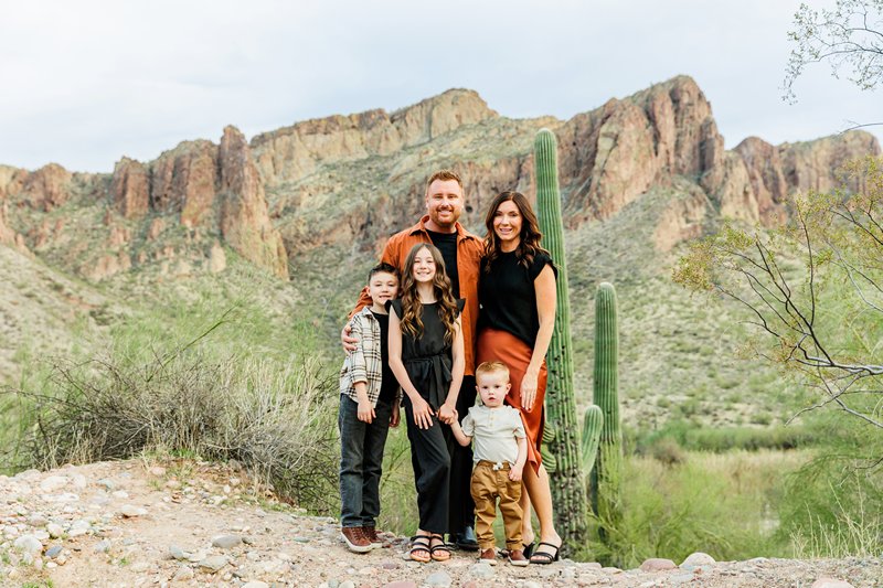 family posing against a beautiful desert backdrop in arizona