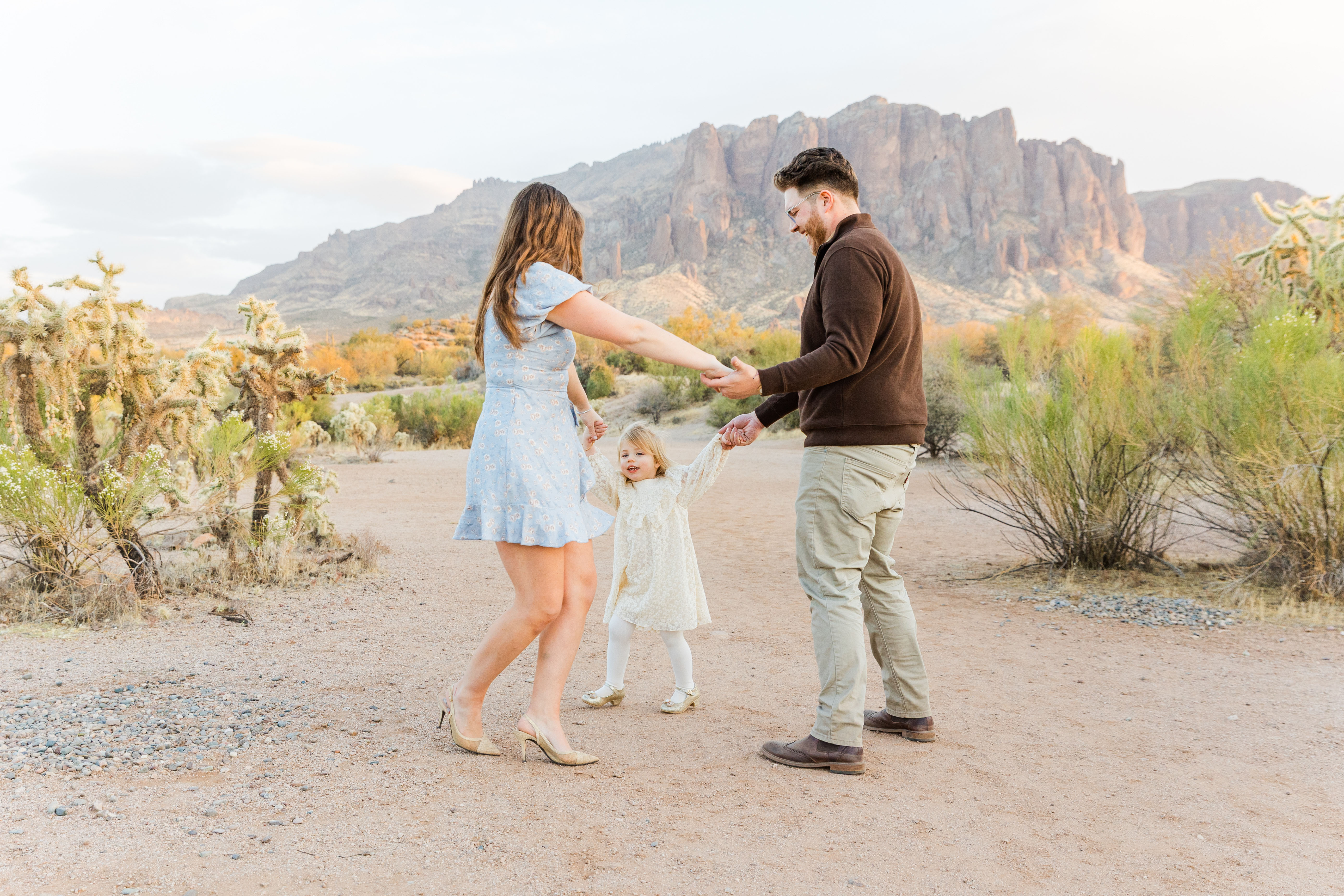 family holding hands and playing in the arizona desert